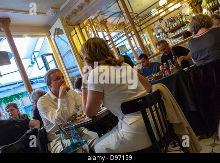 Paris, Cafe France, Couple Sharing Meals inside Traditional French Bistro  Restaurant in Les Halles, 'Le Petit Marcel' interior, parisian bistrot table, Inside Paris restaurants Stock Photo