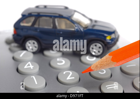 model car on financial calculator with red pencil Stock Photo