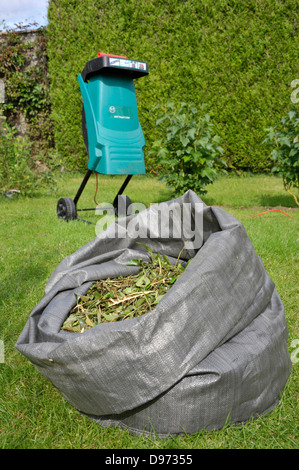 Garden shredder with shredded shrub waste Stock Photo - Alamy
