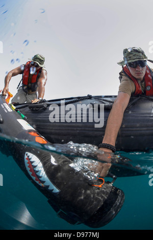 US Navy sailors with the Naval Oceanography Mine Warfare Center deploy an unmanned underwater vehicle to search for mines as part of a training exercise May 18, 2013 in the Arabian Sea. Stock Photo
