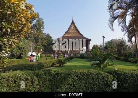 Horizontal view of tourists visiting Wat Ho Phra Keo, or the Temple of the Emerald Buddha in Vientiane. Stock Photo