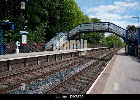 Footbridge bridge connecting platform platforms across train tracks Arnside railway station Cumbria England UK United Kingdom GB Great Britain Stock Photo