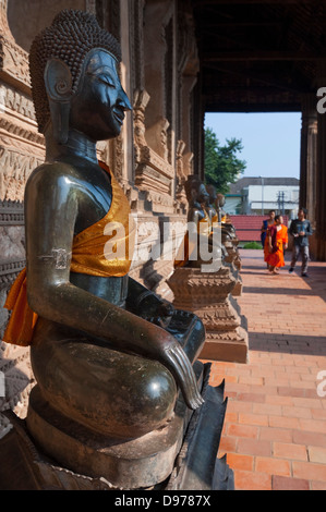 Vertical view of the buddha statues adorning the verandah at Wat Ho Phra Keo, or the Temple of the Emerald Buddha in Vientiane. Stock Photo