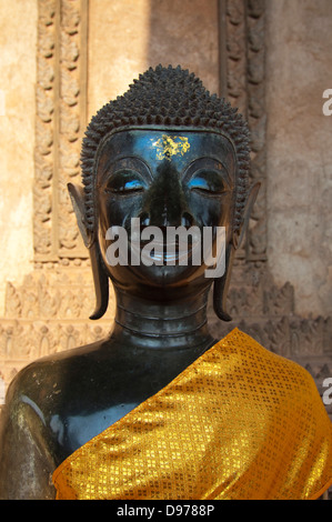 Vertical close up of one of a buddha statue on the verandah at Wat Ho Phra Keo, or the Temple of the Emerald Buddha in Vientiane Stock Photo