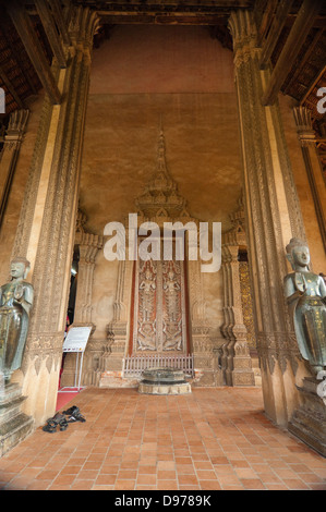 Vertical view of the buddha statues adorning the entrance at Wat Ho Phra Keo, or the Temple of the Emerald Buddha in Vientiane. Stock Photo