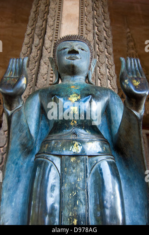 Vertical close up of a huge Buddha statue at the entrance of Wat Ho Phra Keo, or the Temple of the Emerald Buddha in Vientiane. Stock Photo
