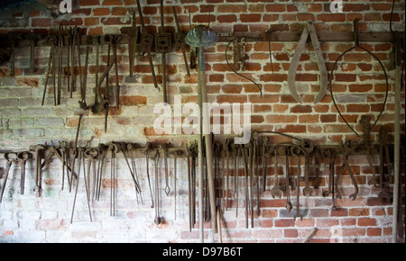 Old rusty farming tools at Helmingham Hall, Suffolk, England Stock Photo