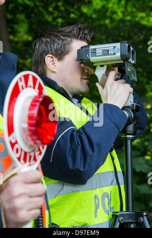 Police speed control, speed measuring with a laser speed gun. Stock Photo