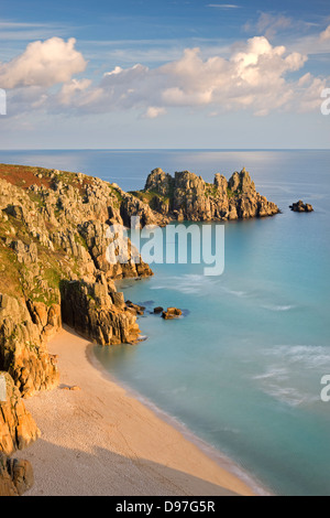 Pednvounder Beach backed by Logan Rock on Treryn Dinas headland, Porthcurno, Cornwall, England. Stock Photo