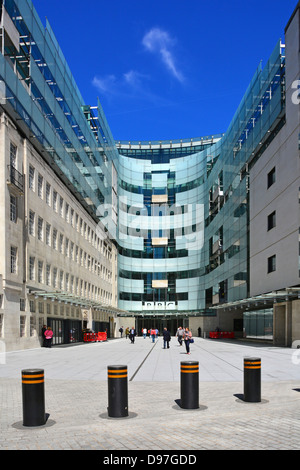 Security bollards across entrance to major modern building additions at BBC Broadcasting House courtyard London England UK Stock Photo