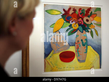 A woman looks at the painting 'Still Life with Bouquet and Buddha' by August Macke in Bonn, Germany, 13 June 2013. The August Macke Haus is hosting the exhibition 'Treasures from the Collection' from 14 June until 29 September 2013. Photo: OLIVER BERG (ATTENTION: For editorial use only in connection with the current report about the exhibition.) Stock Photo