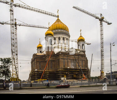 May 24, 1997 - Moscow, RU - Reconstruction of the Cathedral of Christ the Saviour in May of 1997. On the northern bank of the Moskva River, a few blocks southwest of the Kremlin, it is the tallest Orthodox Christian church in the world, with an overall height of 344Â ft (105 m). It sits on the site of an earlier church of the same name, built between 1839 and 1860, commemorating Russiaâ€™s victory over Napoleon. The original church was dynamited and reduced to rubble in 1931, by order of Stalin, and the site was transformed into the world's largest open air swimming pool. In 1994 the pool was  Stock Photo