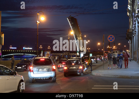 View of the opened Troitsky Bridge with jam on embankment. Saint Petersburg, Russia. White nights and Scarlett Sails celebration Stock Photo