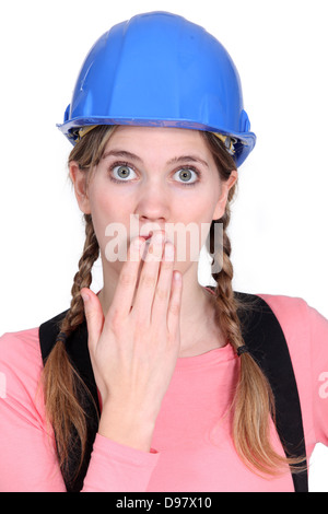 Embarrassed female builder Stock Photo