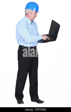 Senior architect typing on laptop Stock Photo