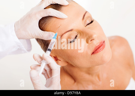 doctor giving face lifting injection on mature woman Stock Photo