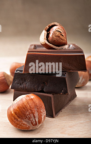 Pile of  milk chocolate and dark chocolate bars with hazelnuts Stock Photo