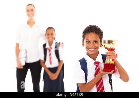 cute schoolboy holding trophy in front of teacher and classmate Stock Photo