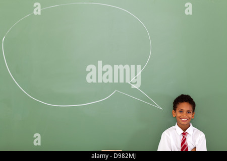 elementary schoolboy with speech bubble drawn on chalkboard Stock Photo