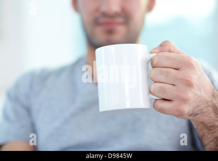 Close-up of male hand holding mug Stock Photo