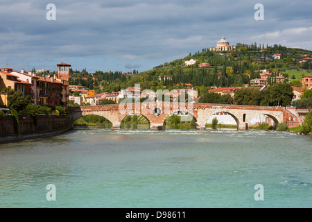 Panoramic view of Ponte Pietra in Verona, Italy in a bright sunny day with dramatic clouds at the background. Stock Photo