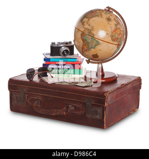 Still-life photo of an old brown leather suitcase with camera, travel guides, world globe, sunglasses, stamped passport and cash Stock Photo