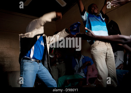 Football fans celebrate in their home after Bafana Bafana scored a goal in the 2010 FIFA World Cup. Stock Photo