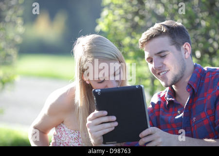 a young couple looking at a tablet pc Stock Photo