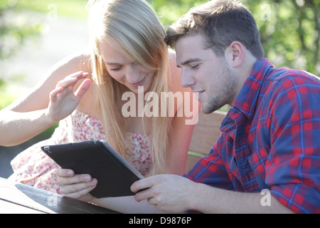 a young couple looking at a tablet pc Stock Photo