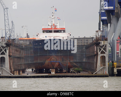 Ship in dry dock at Damen Shiprepair for maintenance or repair in the port of Rotterdam, the Netherlands Stock Photo