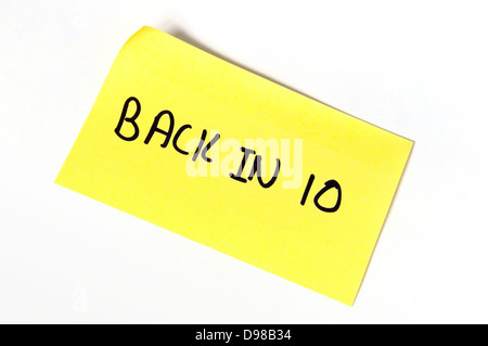 Back in 10 written on a yellow post-it note Stock Photo