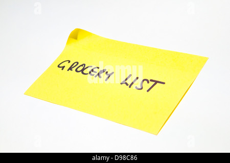 'Grocery list' written on a yellow post it note Stock Photo