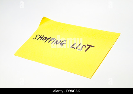 'Shopping list' written on a yellow sticky note. Stock Photo