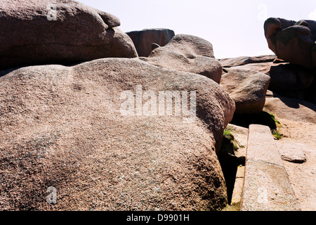 large Pink granite boulders on sea coast in Brittany, France Stock Photo