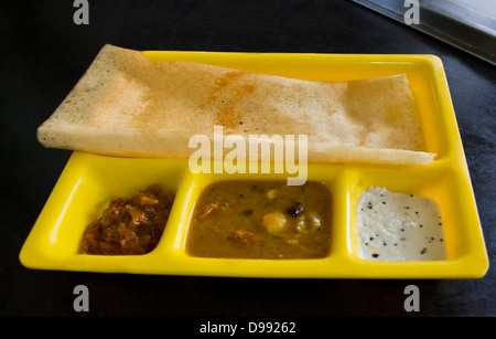 Dosa with chutneys and sambhar on a restaurant table, Chennai, Tamil Nadu, India Stock Photo