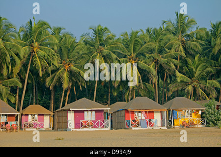 Cocohut beach holiday bungalows on stilts Agonda beach, Goa India Stock Photo