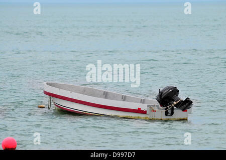 Small fishing boat in the middle of the ocean water Stock Photo