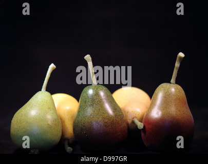 Five pears- two yellow and three green on a black background Stock Photo