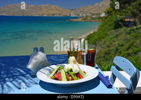 Greek salad on table in 'Philosphia' beach taverna, Pefkos, Rhodes (Rodos), The Dodecanese, South Aegean Region, Greece Stock Photo