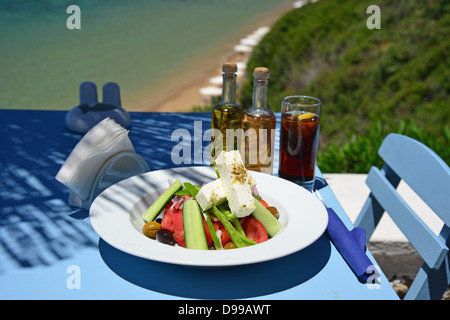 Greek salad on table in 'Philosphia' beach taverna, Pefkos, Rhodes (Rodos), The Dodecanese, South Aegean Region, Greece Stock Photo