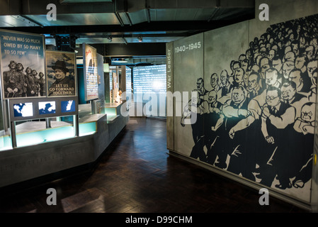 LONDON, United Kingdom — Exhibits in the Churchill Museum at the Churchill War Rooms in London. The museum, one of five branches of the Imerial War Museums, preserves the World War II underground command bunker used by British Prime Minister Winston Churchill. Its cramped quarters were constructed from a converting a storage basement in the Treasury Building in Whitehall, London. Being underground, and under an unusually sturdy building, the Cabinet War Rooms were afforded some protection from the bombs falling above during the Blitz. Stock Photo