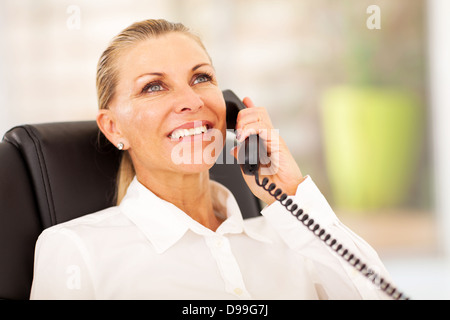 senior businesswoman talking on the phone in office Stock Photo