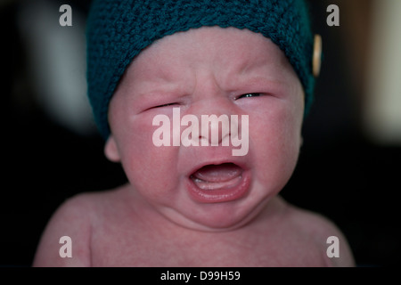 red faced Newborn baby upset and crying Stock Photo
