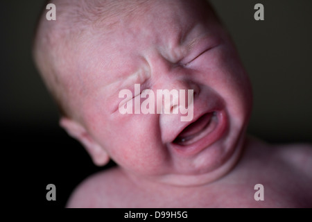 red faced Newborn baby upset and crying Stock Photo