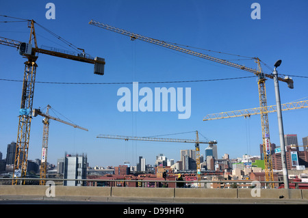 Five large tower cranes working in central Johannesburg. Stock Photo
