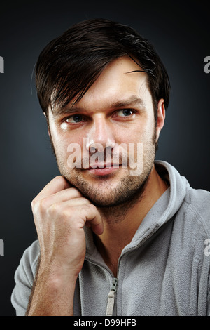 Low key studio portrait of an pensive handsome young man Stock Photo