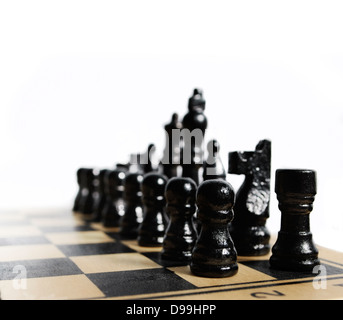 Black chess pieces on chess board isolated over white Stock Photo