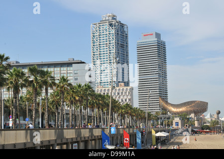 Barcelona, Spain - July 07, 2012: Tourists on promenade admire whale sculpture in Barceloneta Stock Photo