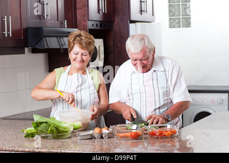 elderly couple cooking in home kitchen Stock Photo