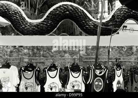 WAT KARON MARKET, KARON, PHUKET, THAILAND FEBRUARY 9 2013: Vendor's market stall sells souvenirs and garments in Buddhist Temple